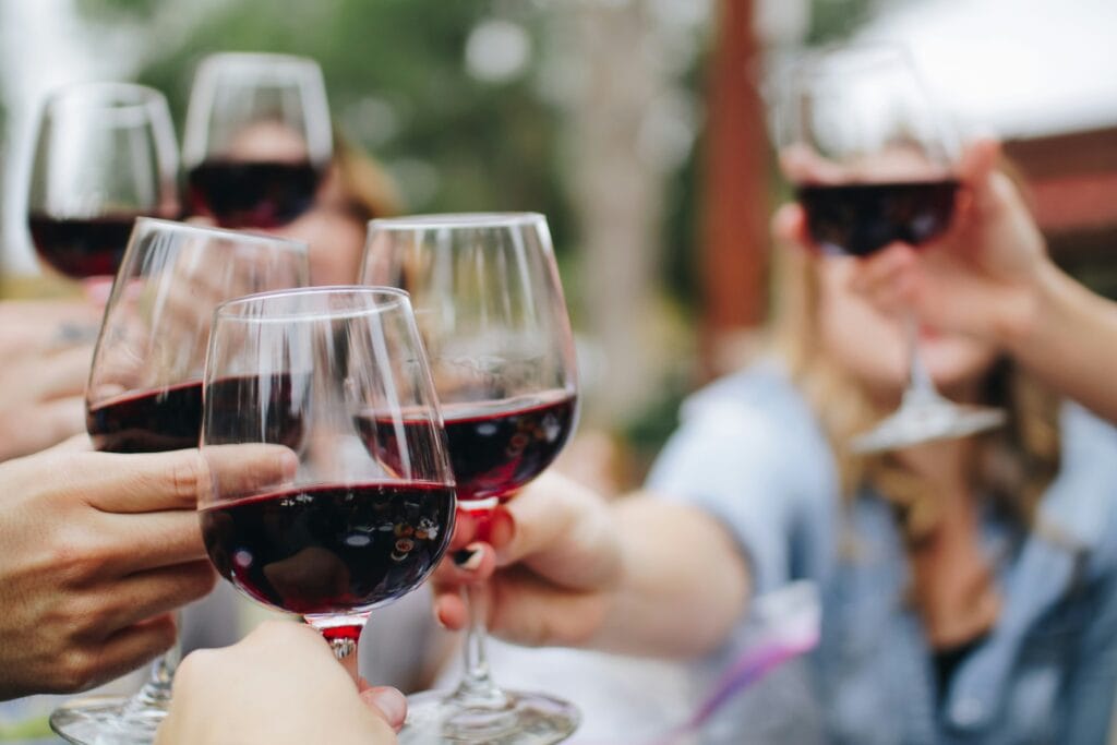 People cheers their glasses of red wine