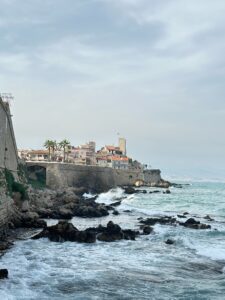 Picturesque coastal town with rocky shoreline and historic Mediterranean architecture in Antibes, France