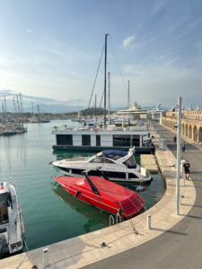 Luxurious yachts docked at a scenic marina in Antibes, France on a sunny day.