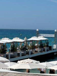Beachside Hotel Martinez with white umbrellas and ocean view in Cannes, France.