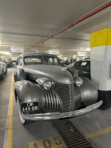Vintage silver Cadillac parked in an underground parking lot in Cannes, France.