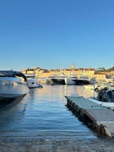 Luxurious yachts docked at charming Mediterranean harbor in sunny Saint Tropez, France.