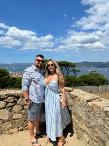 Vast sea view with boats and turquoise water, Mediterranean coast, lush greenery, and scenic landscape.