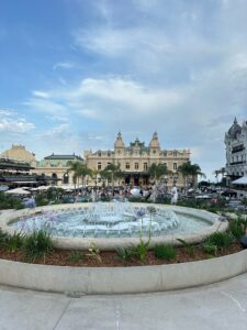 Elegant fountain in front of a historic casino building at the Monte Carlo Casino in Monaco, scenic cityscape view.