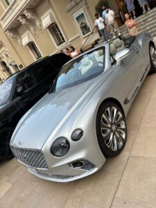 Luxury silver Bentley convertible sports car parked outside Monte Carlo Casino in Monaco