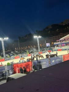 Nighttime equestrian show at Longines Global Champions Tour in Monaco, illuminated arena with horses and spectators.