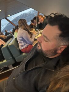 Relaxed man sleeping on a boat with mountain view in background in Norway