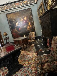 Intricate antique furniture and classic paintings in Prince's Palace in Monaco.