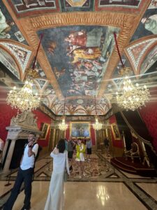 Ornate Royal Hall with Baroque chandeliers and historic ceiling art in Prince's Palace in Monaco.