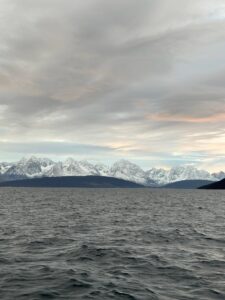 Snow-capped mountain range over a fjord in Norway, scenic landscape, majestic wilderness, travel destination.